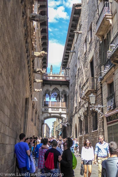 The Bridge of Sighs joins to buildings over a pedestrian zone in Barcelona
