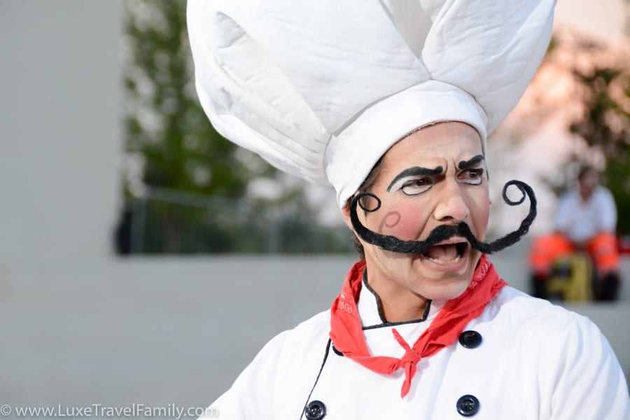 Cirque du Soleil actor in chefs hat with big handlebar moustache at Expo 2015