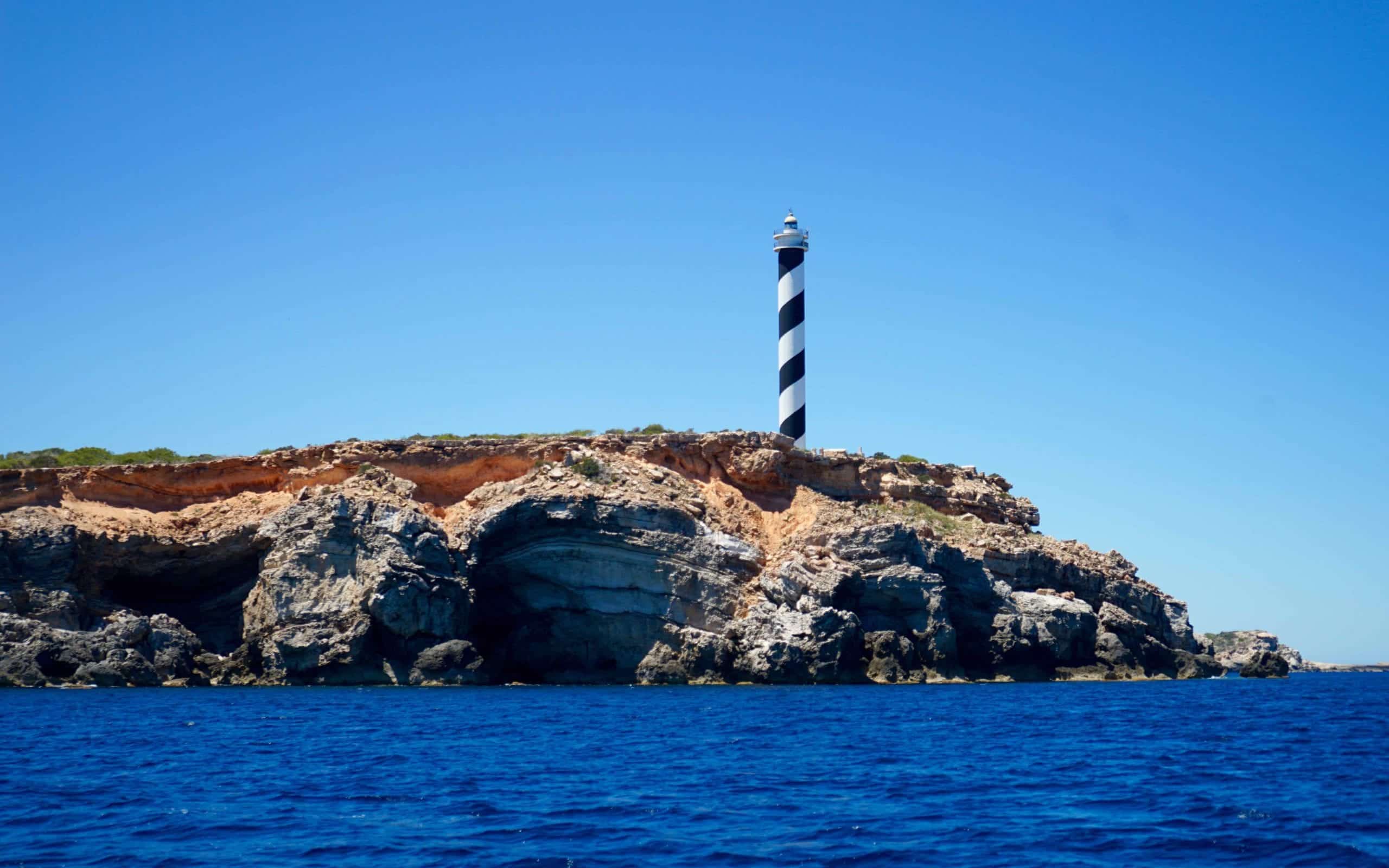 Charter a boat in Santa Eulalia visit Portinatx lighthouse