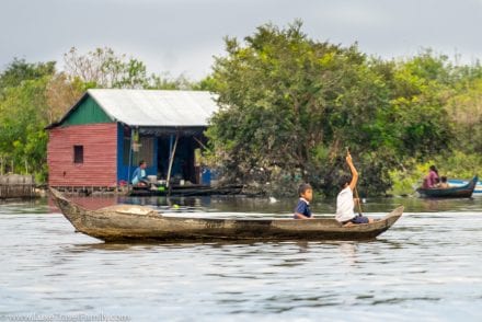 school kids kayaking on Tonle Sap Lake with Smiling Albino