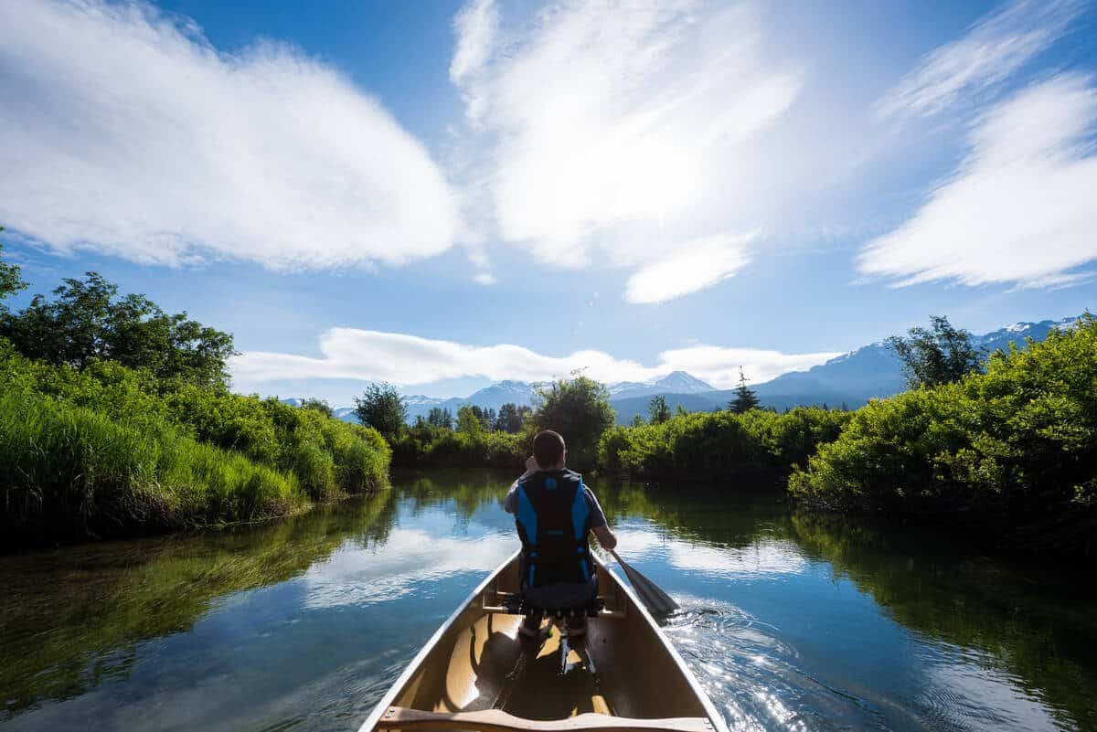 Person paddling canoe Whistler's River of Golden Dreams